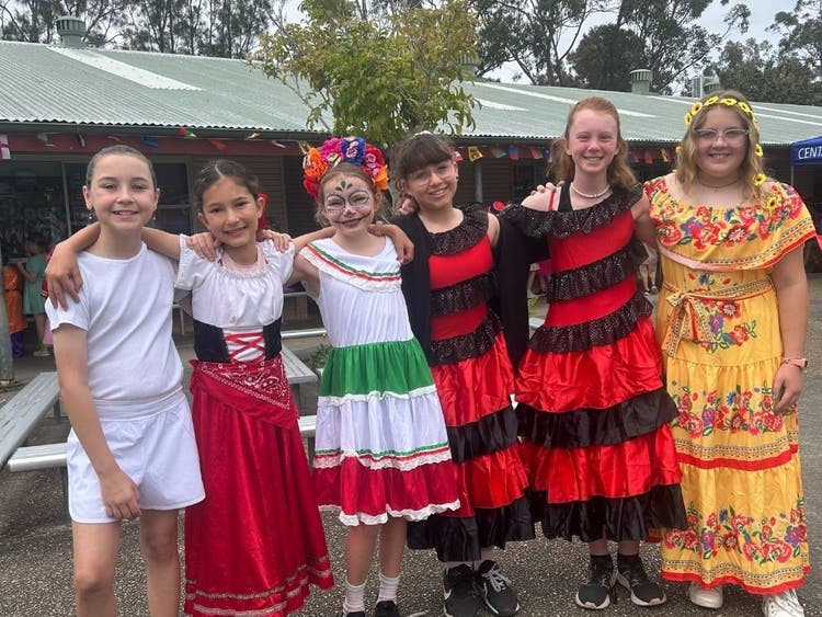 6 students dressed in colourful multiculural outfits